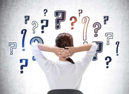 Rear view of a relaxed businesswoman with hands behind her head wondering about career...