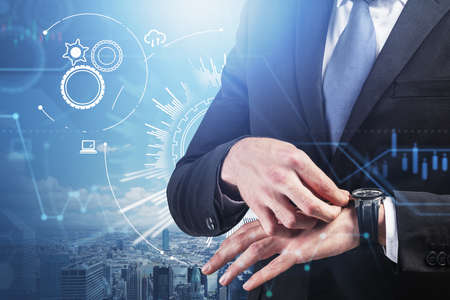 Businessman in suit setting the watch on background of rooftops, double exposure of icons and process .. Concept of international communication, view on skyscrapersの写真素材