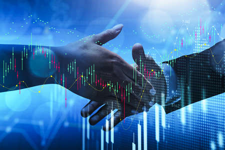 Two partners shaking hands, digital graph rising and falling. Business corporate communication,...