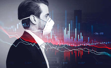 Digital graph falling, office manager in suit standing wearing coronavirus protective mask pensive, background of skyscrapers. Stock statistics, candlesticks changes on foregroundの写真素材