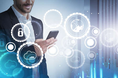Businessman holding smartphone in hand, internet network icons. Hand with device, background of...