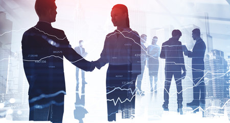 Business people shake hands, double exposure of social network and graph changes. Skyscrapers and city buildings, concept of international connections and teamworkの写真素材