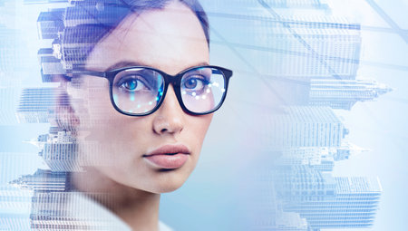 Portrait of attractive businesswoman wearing glasses and looking straight toward the camera. Double...