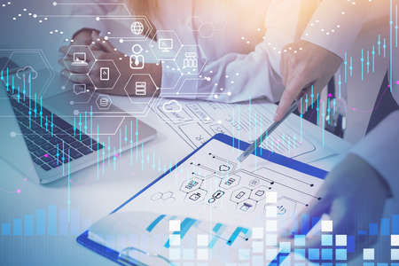 Businesswoman hand point at tablet, laptop and papers, corporate network. Stock market changes, icons of network. Concept of corporate communication and tradingの写真素材