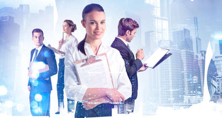 Office woman and man with business papers, background of city buildings blurred. Concept of business...