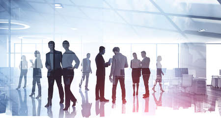 Silhouettes of diverse business people working together, toned image of office interior and skyscrapers. Concept of modern office with managers, partnersの写真素材
