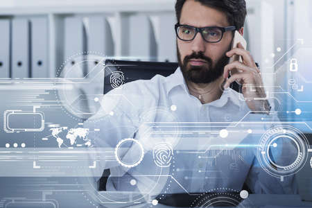 Office man bearded with laptop talking on the smartphone, double exposure hologram of network icons,...