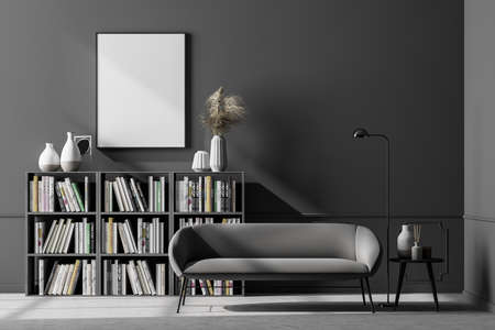 Cozy waiting room interior with a comfortable couch and an empty poster on the gray wall above the...