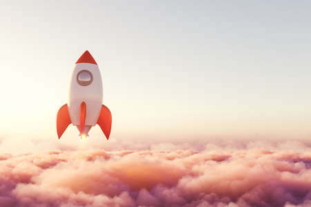 Launched rocket is rising above pink pastel clouds towards goals, aims and success. Concept of necessity of inspiration and motivation to suggest creative idea in order to found business startupの写真素材