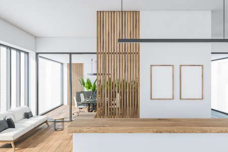 Bright modern minimalist office room interior with two empty poster, wooden parquet floor, panoramic window, reception desk, computer, glass partition. Concept of business meeting place. Close up viewの写真素材