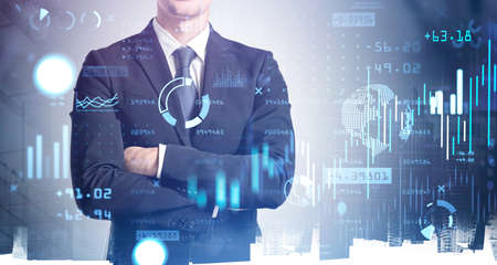 Businessman wearing formal suit in crossed arms pose. Digital interface with diagrams and graphics....