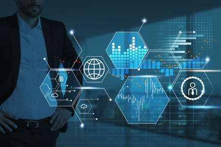 Confident businessman wearing formal suit is standing in hands on hips pose. Hologram of the hud...