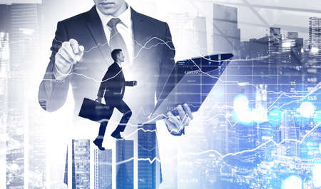 Businessman wearing formal suit is walking over the city skyscraper, his colleague is holding the...