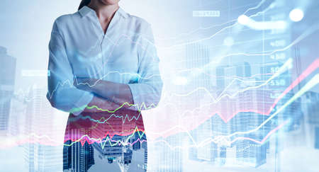Office woman in white shirt standing pensive, buildings and stock market graph changes with numbers double exposure. Concept of office worker, trader and financial advisorの写真素材