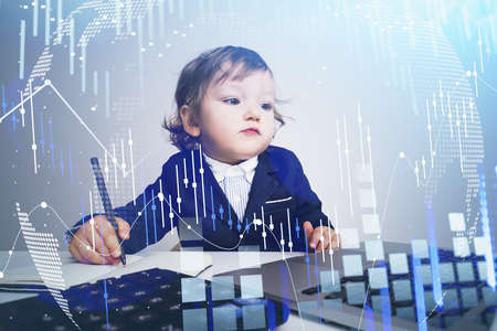 Little child boy with pen and laptop. Digital graph rising and falling, data information. Office...