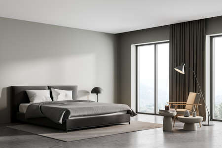Gray bedroom interior with bed and seat with coffee table and lamp, window with countryside view and concrete floor. Mockup copy space in sleeping room, 3D renderingの写真素材