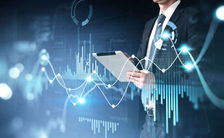 Office man using digital tablet, stock market changes, business graph bar chart. Double exposure of...