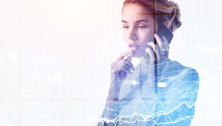 Businesswoman pensive using phone calling, stock market changes and business graph chart. Double...