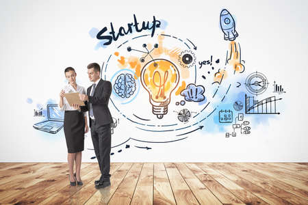 Two young professionals checking the documents, colorful doodle icons and lightbulb. Drawing with arrows, rocket, pie chart and network icons. Concept of fresh idea and business planの写真素材