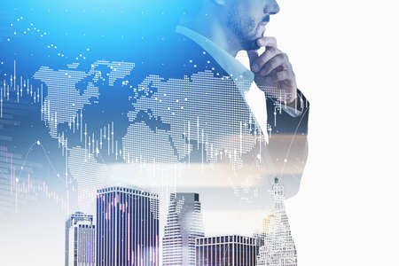 Beard businessman thoughtfully looking at skyscrapers and cityscape, stock market lines graph changes, double exposure. Concept of financial trader and financial advisorの写真素材