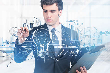 Office man pen point hud of business process icons and light bulb, documents in hand. Drawing with arrows, pie chart and finance graphs. Concept of new idea and business planの写真素材