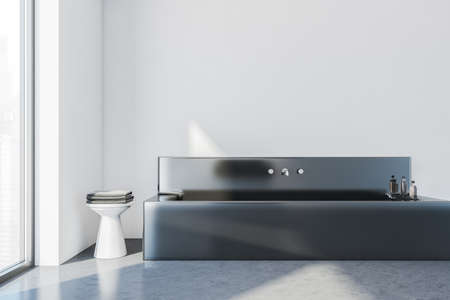 White wall modern stylish hotel bathroom interior, with black square ceramic bathtub. Panoramic...