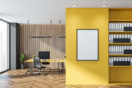 Light office room with table and desktop computer, armchairs on parquet floor. Shelf with folders, plant in the corner and windows with city view. Mockup canvas frame on yellow wall, 3D renderingの写真素材