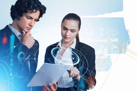 Two business people looking at the paper pensive. Double exposure with earth globe and stock market changes, data information symbols. Concept of financial analysis and teamworkの写真素材