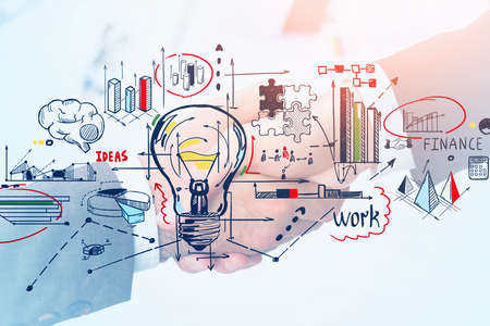 Close up businessman and businesswoman shaking hands, lightbulb drawing and financial graphs and business analysis flowcharts. Concept of deal, agreement and starting of new businessの写真素材