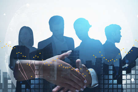 Concept of partnership. Businessman and businesswoman handshake over financial downtown cityscape...