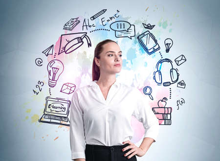 Young office woman in white shirt with confident look. Colorful doodle sketch drawing of formula, light bulb and circuit of icons on blue wall. Concept of study and learning processの写真素材