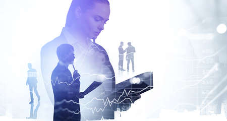 Office woman reading notes and businessman thinking. Business people silhouettes and stock market graph changes, business bar chart, double exposure with skyscrapers. Concept of financial analysisの写真素材