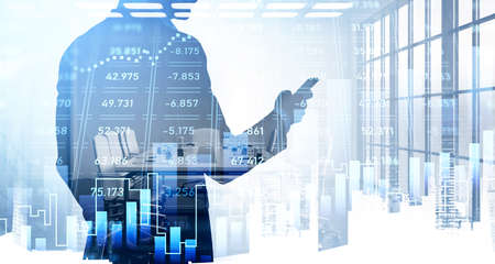 Rear view of businessman silhouette with smartphone in hands analysing stock market changes, double...