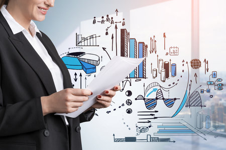 Office woman studying a business file, smiling. Business strategy plan double exposure with panoramic view on skyscrapers, blue drawing with graph changes and dynamics. Concept of financial analysisの写真素材
