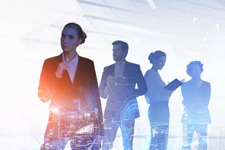 Group of business people working together over digital hud interface and New York night cityscape with lights. Concept of teamwork, cooperation and network in international hi tech business.の写真素材