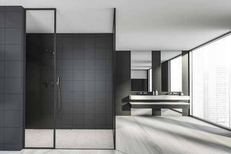 Modern design bathroom interior with glass shower cabin, double sink countertop, silver faucets. Panoramic window with skyscrapers city view. Wooden parquet and black tiled walls. 3d rendering.の写真素材