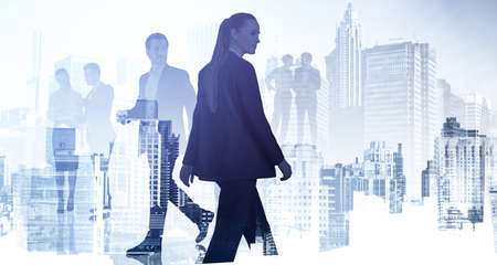 Silhouettes of diverse business people rushing and looking for solutions in abstract office space with skyscraper city view. Business development concept. Double exposureの写真素材