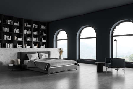 Gray bedroom interior with bed and linens on concrete floor, side view, big bookshelf with books and decoration, armchair with lamp and coffee table. Art bedroom with panoramic windows, 3D renderingの写真素材
