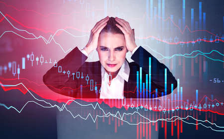 Woman in suit sitting and holding her hand, depressed looking at the screen. Stock statistics hud...