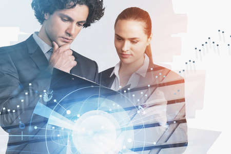 Businessman and businesswoman looking into business report. Data graph and digital interface hud...