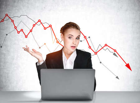 Boss woman with laptop talking, video call, falling stock market lines on background. Financial...