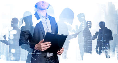 Office man in business suit holding documents, toned image, double exposure of business buildings....