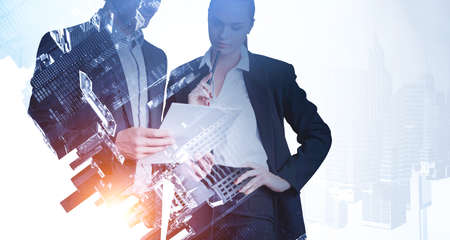 Businessman and businesswoman in black suit serious look, analysing paper document. Business...