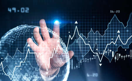 Businessman hand touching digital glass screen with stock market changes. Candlesticks, data...