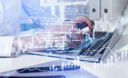 Office man fingers typing on keyboard of laptop on the table. Stock market changes, forex dynamics,...