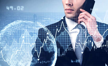 Handsome businessman in formal suit with tie or stock trader analyzing stock graph forecast taking...