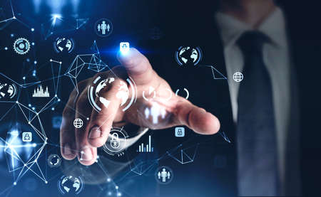 Businessman in black suit touching data security icons on virtual screen with digital interface by...