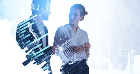 Businessman and businesswoman talking on background of skyscrapers and financial chart with lines...