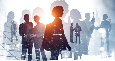 Diverse business people rushing and working with documents. Panoramic sunset New York cityscape with downtown skyscrapers. Silhouettes of Business colleagues. Double exposureの写真素材