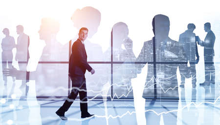 Businessman walking along panoramic office. Diverse business people working together. Skyscrapers...